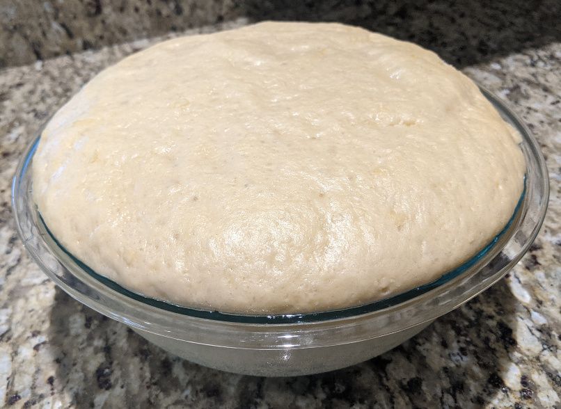 Bowl of challah dough after first rise